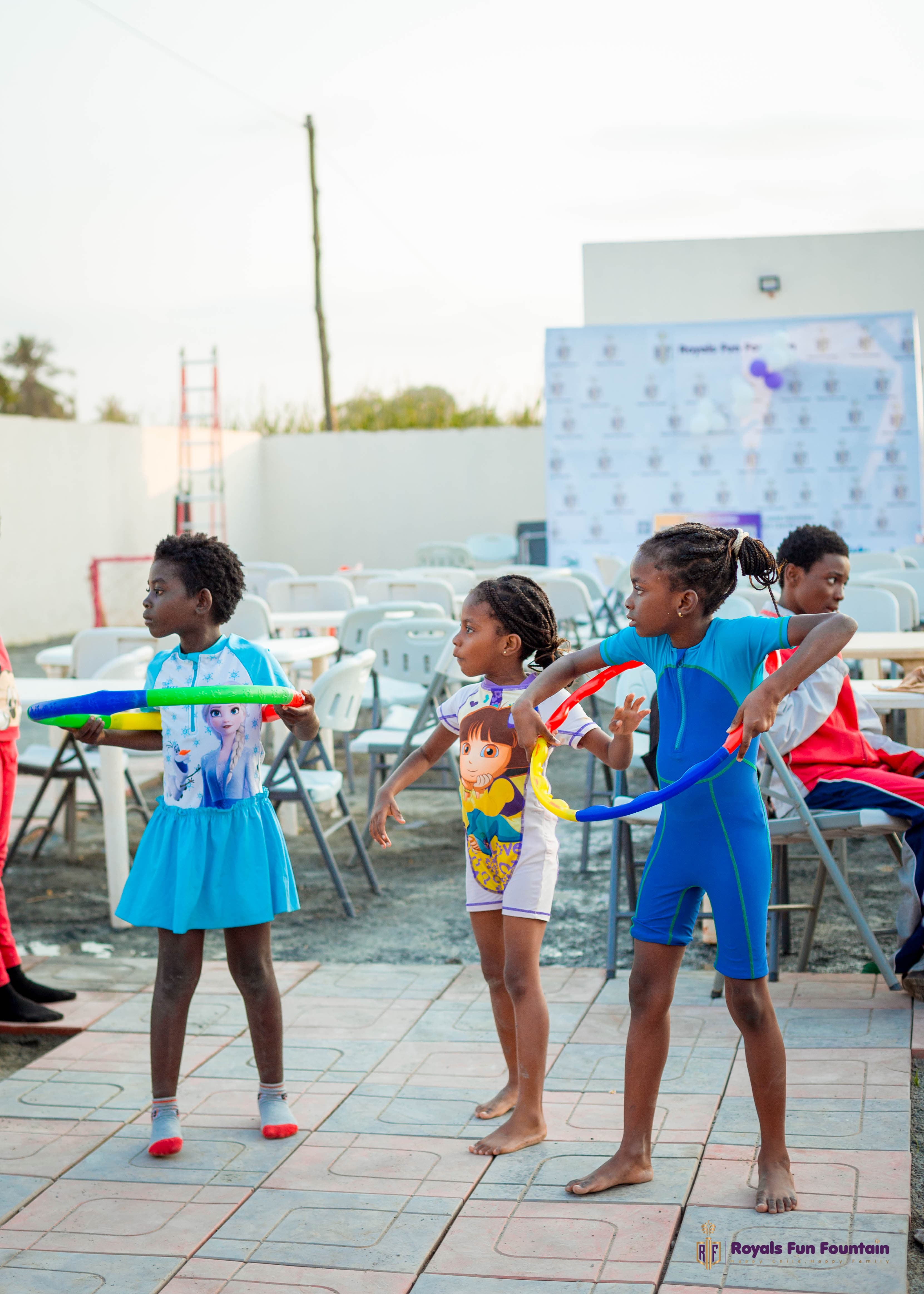 Girls spinning hula hoops at a fun day
