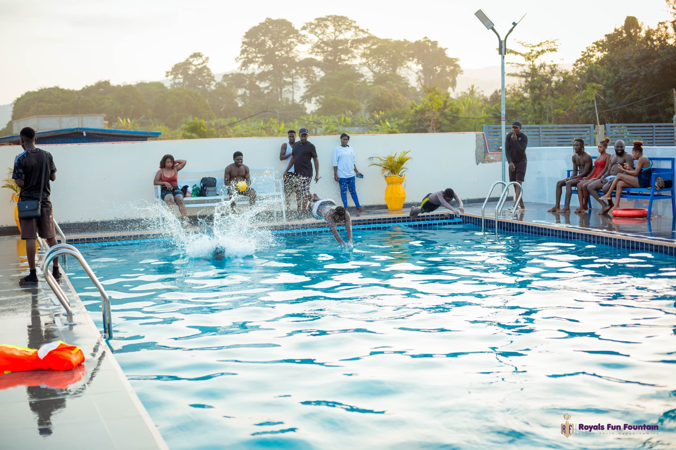 The adult swimming pool at sunset, with a swimmer diving in
