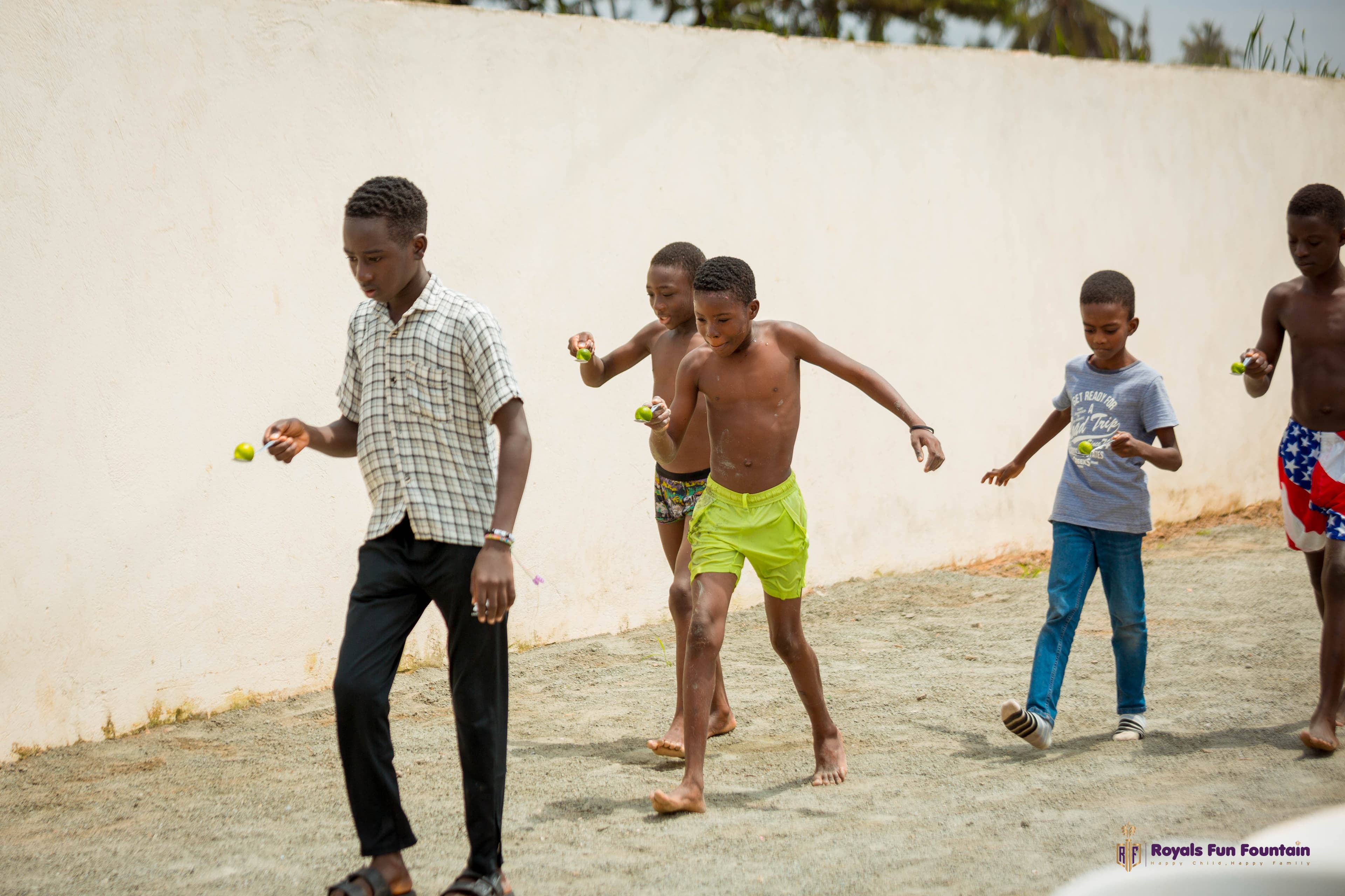 Boys racing in an egg-and-spoon race