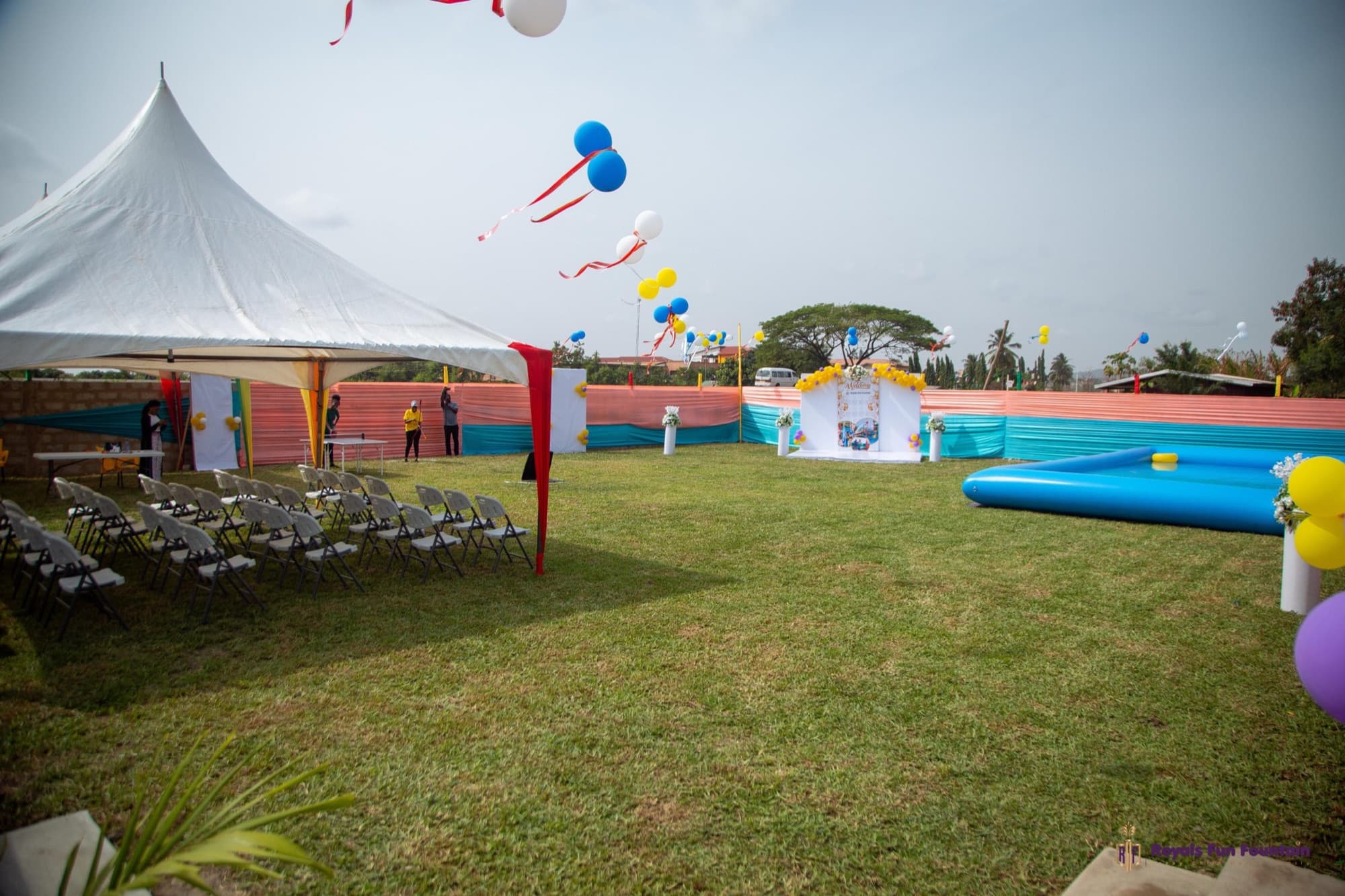 The garden lawn set up with a marquee, chairs and balloons