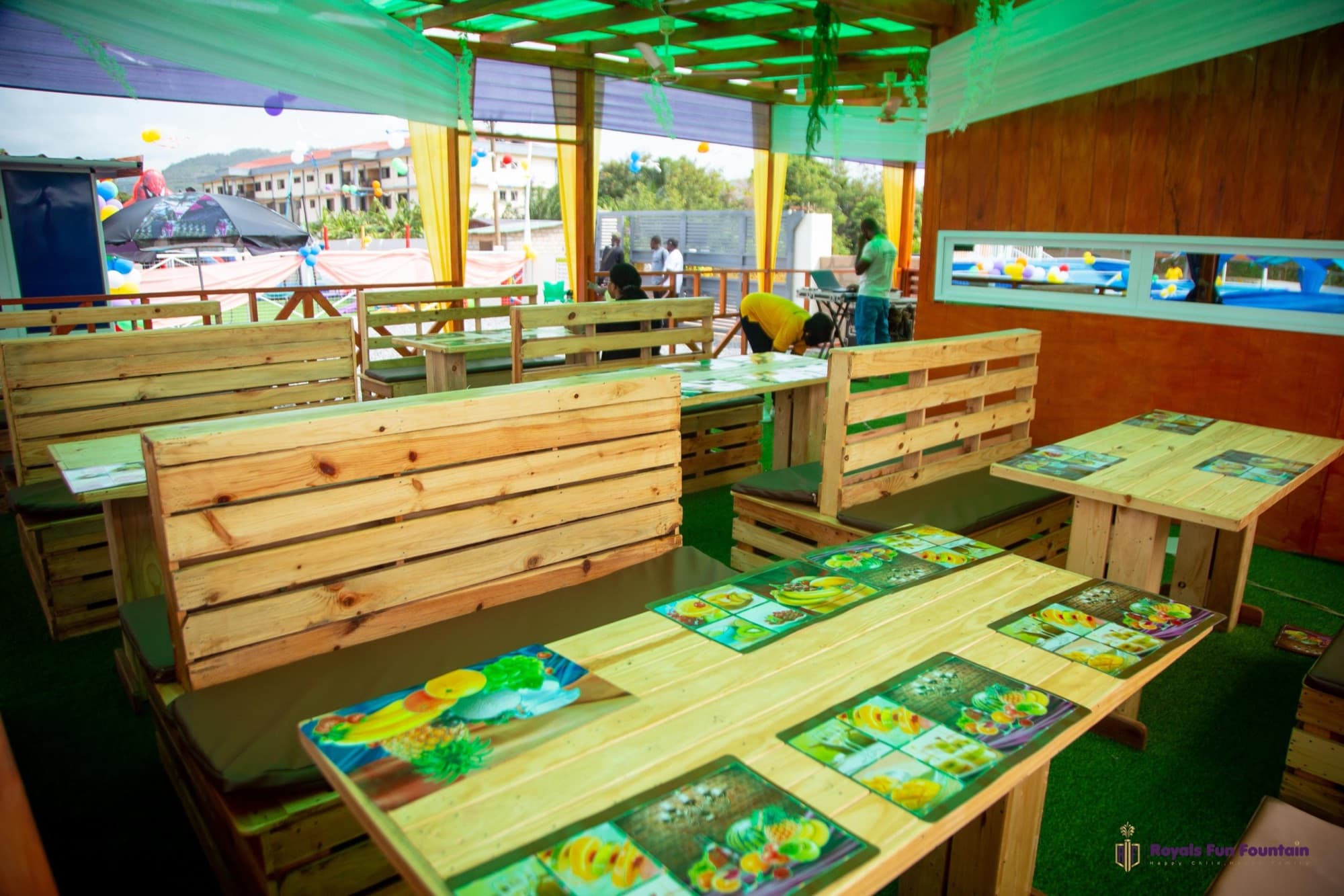 Wooden tables and benches in the open-air restaurant